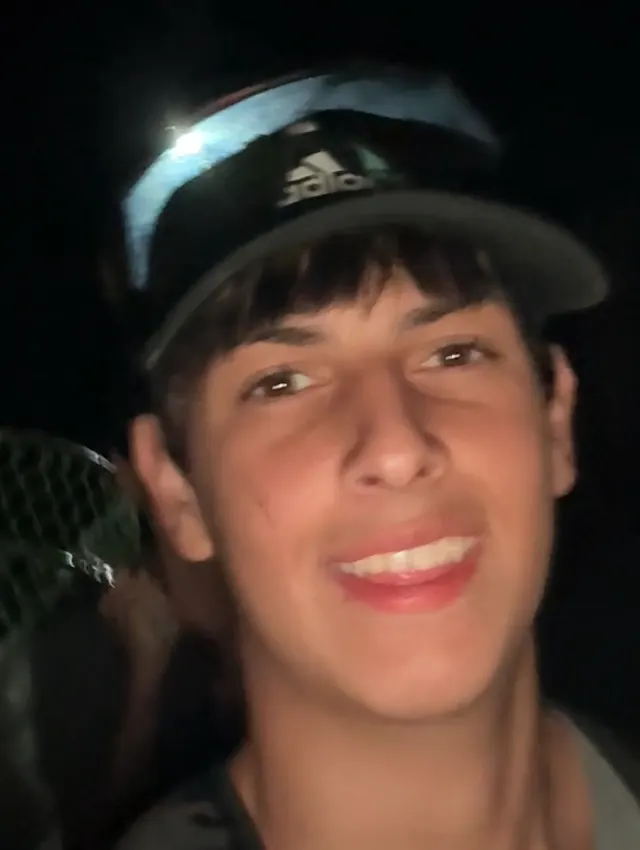 Ruben smiling in a cap on a night out